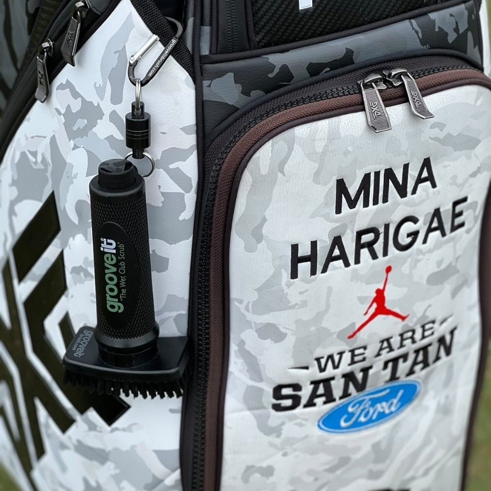 Grooveit “The Wet Club Scrub” golf brush attached to pro golfer Mina Harigae’s custom camo golf bag with Jordan and San Tan Ford branding.